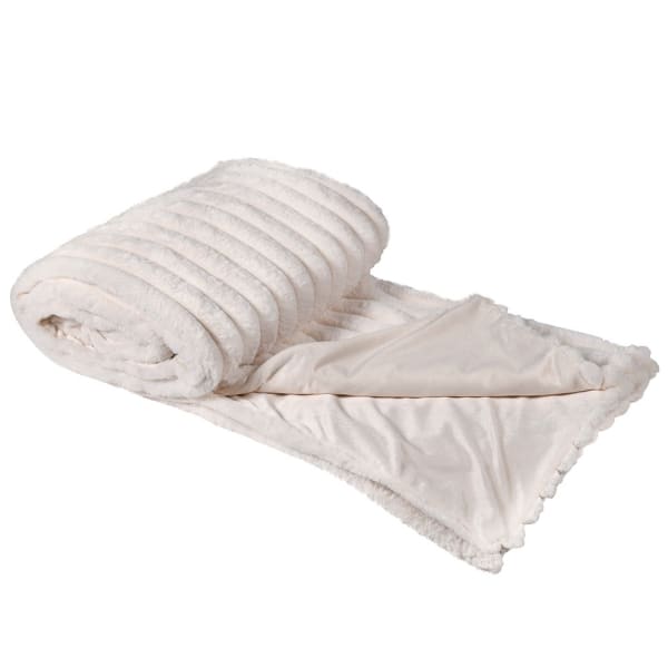 Cream faux fur throw, rolled up with one size folded over.