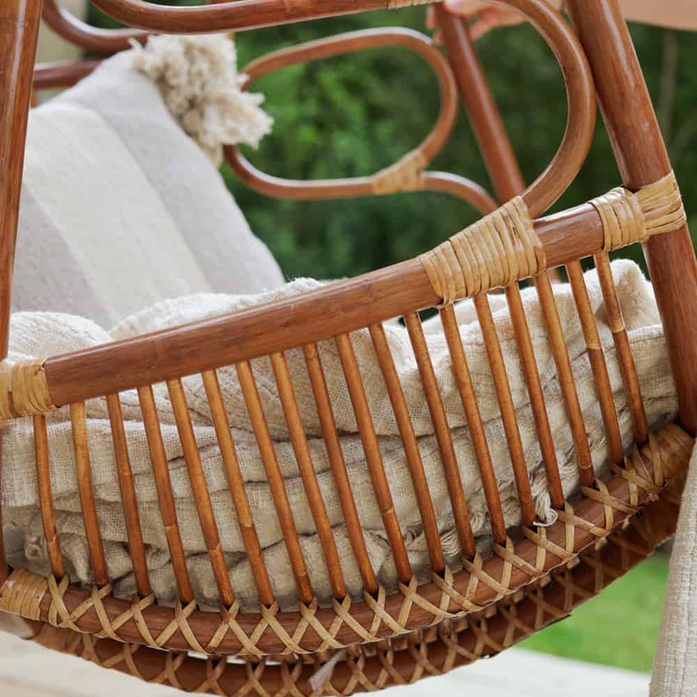 Close up off woven rattan detail on hanging egg swing chair.