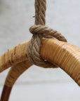 Close up of rope and woven top on rattan hanging egg swing chair.