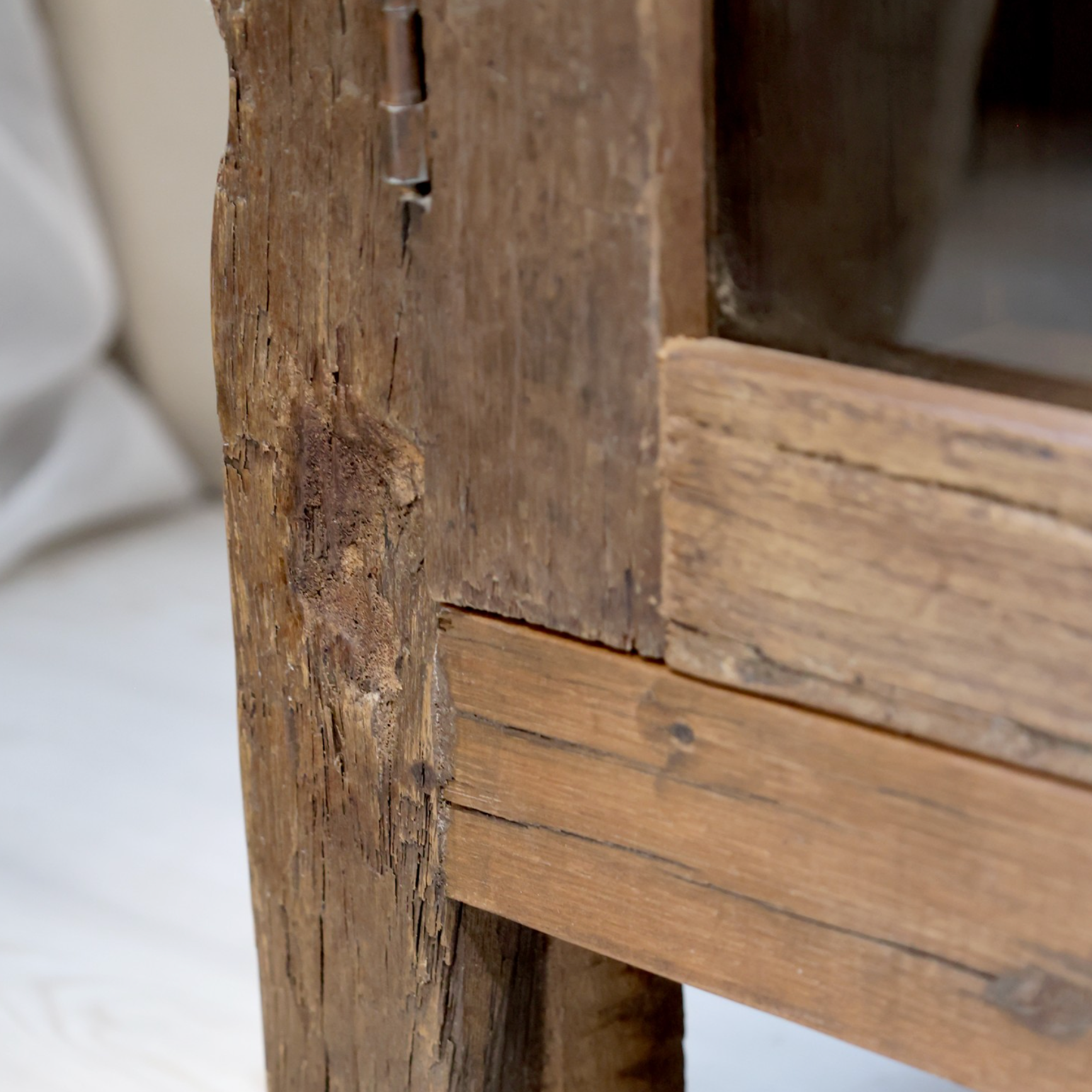 Reclaimed wooden cabinet with glass doors.