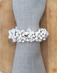 Wooden Napkin Ring with White Berries on a wooden plate.