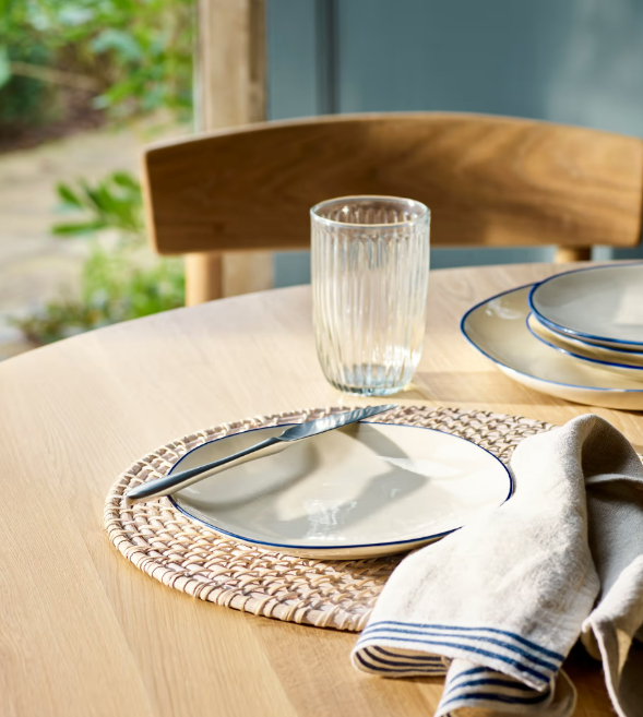 Blue and white stoneware side plates with cutlery on table.