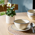 White and blue stoneware cereal bowls on dining table.