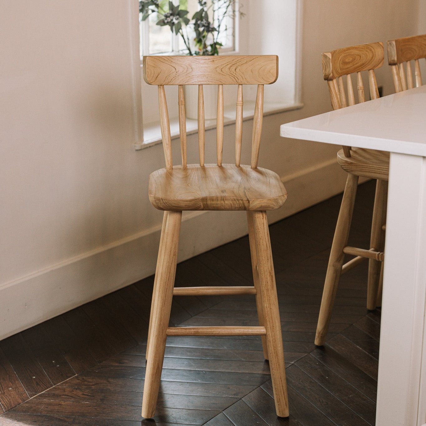 Three Farmhouse Bar Stools With Backs in dark wood kitchen.