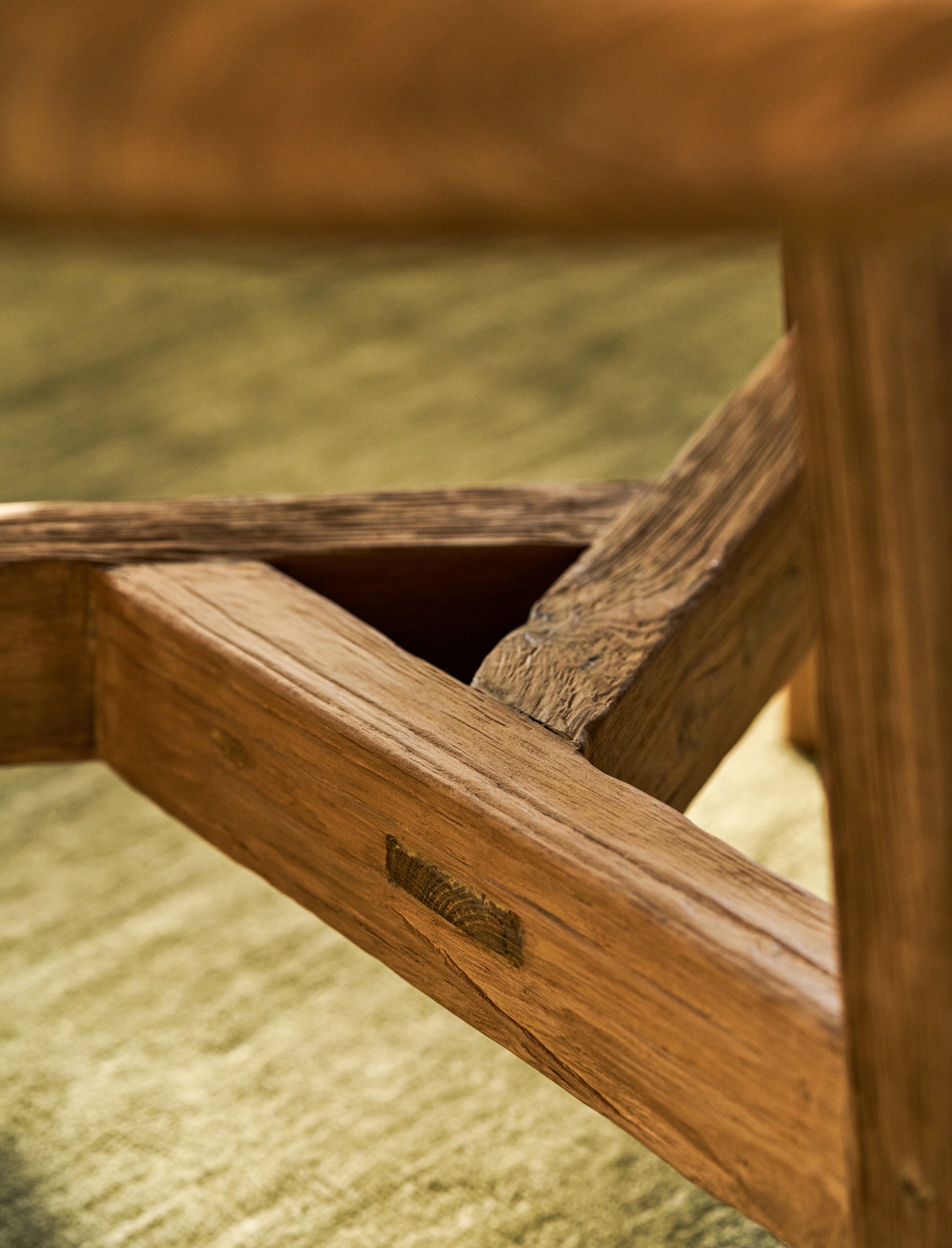 Close-up of a round wooden table with a blurred background