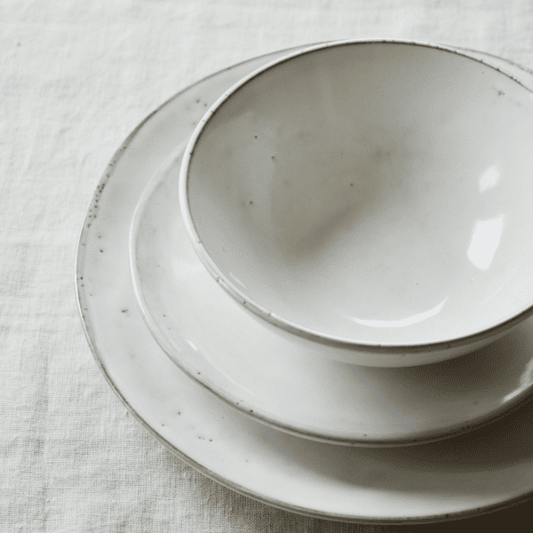 The Broste Copenhagen Nordic Sand dinnerware on a linen tablecloth
