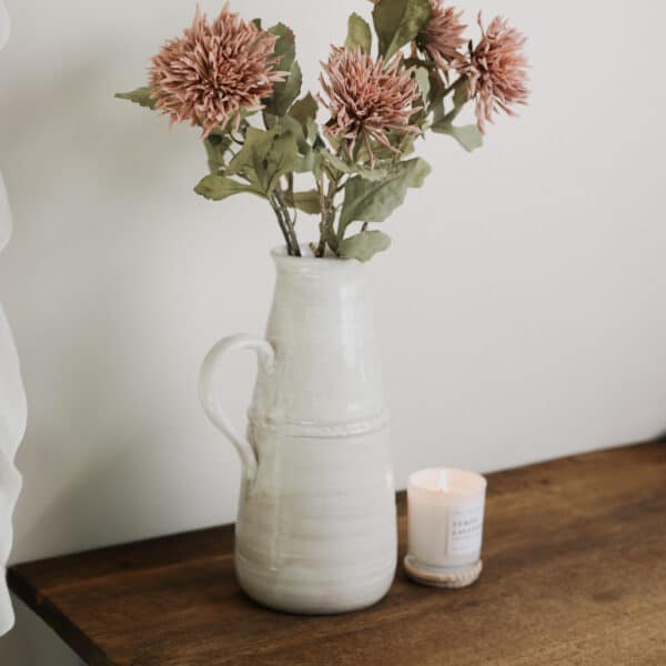 Dusty pink coloured Dahlia flowers in a vintage vase.