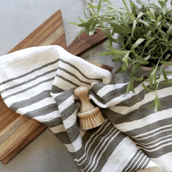 striped tea towel on a wooden chopping board.