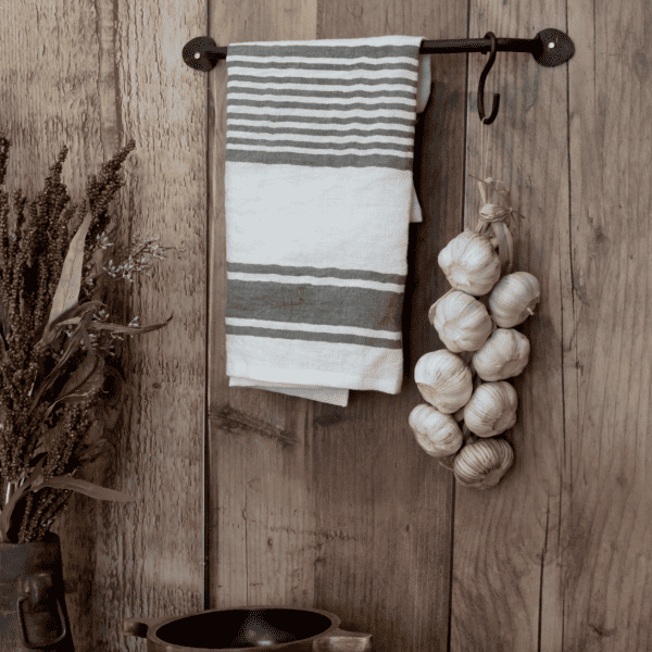 striped tea towel on hanging rail with garlic