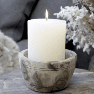 reclaimed wooden bowl with a cream candle inside.