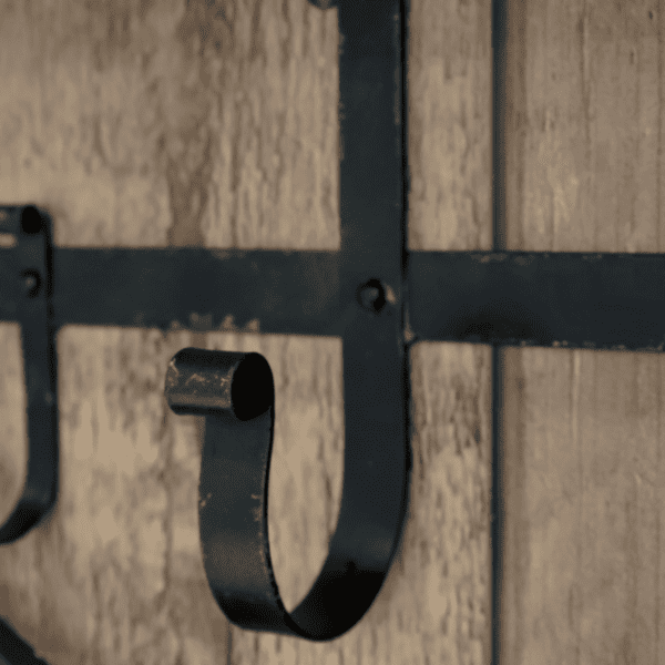 rustic metal hook against a wooden wall