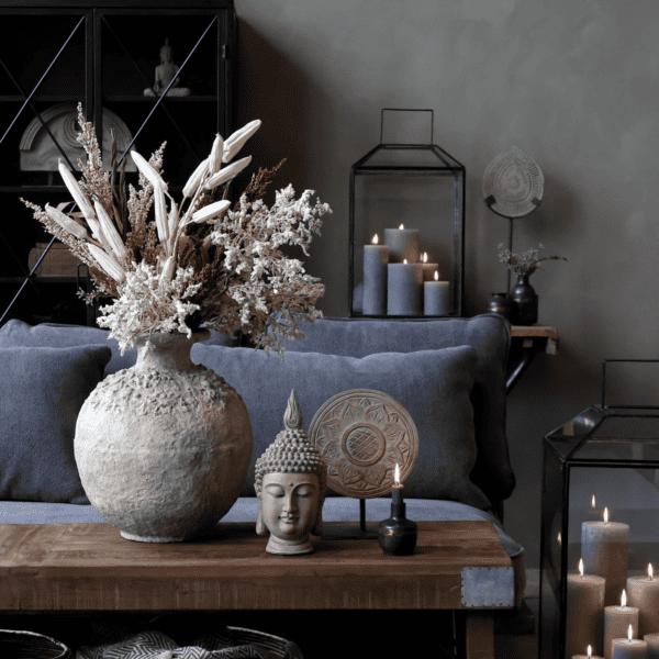 Living room scene with a rustic vase displaying dried flowers