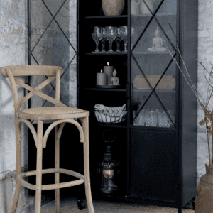 Cross Cross bar stool against a black glass cabinet.