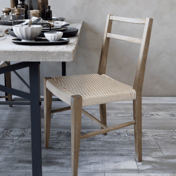 Wicker dining chair at rustic dining table