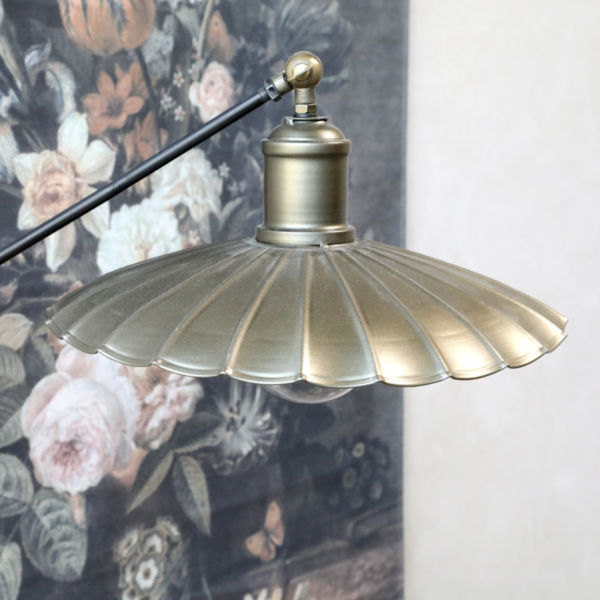 A vintage style floor lamp, finished in an antique brass colour.