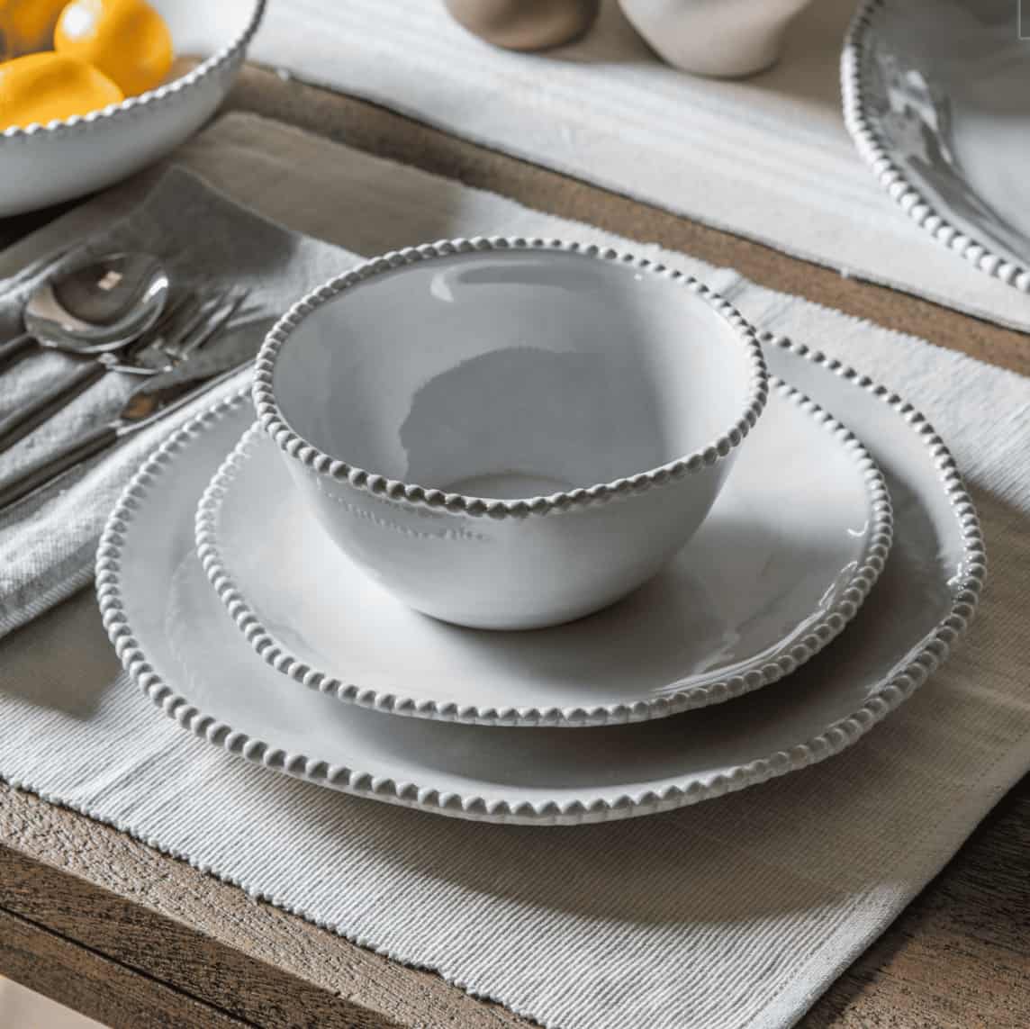 Set of 4 beaded dinner plates by gallery interiors.  With their elegant beaded accents, these side plates effortlessly elevate any meal, whether it’s a casual family gathering or an intimate dinner with friends.