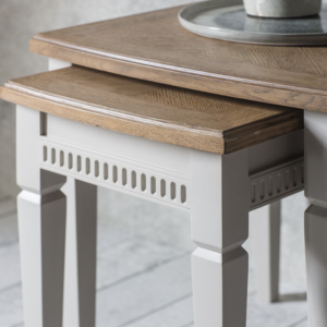 The smaller table neatly slots under the larger one. Made from mahogany in a calming taupe colour.