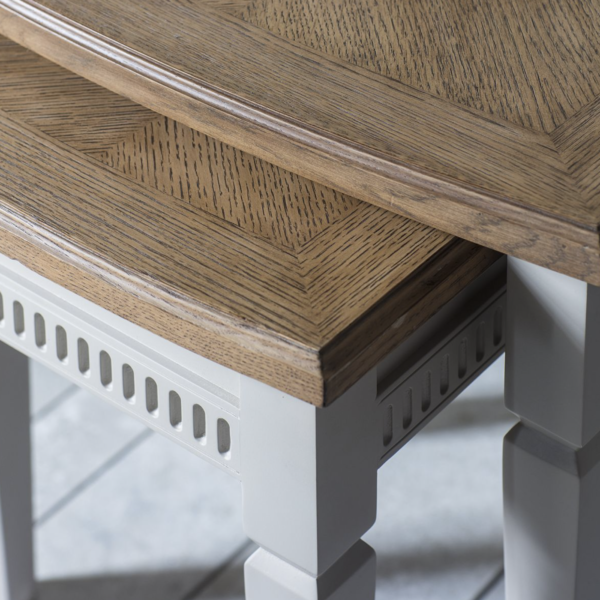 The smaller table neatly slots under the larger one. Made from mahogany in a calming taupe colour.