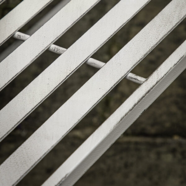 With a chic country style, this bench is perfect for sitting and enjoying the sun. Crafted from metal with a soft white finish, the bench's sweet design details make it a beautiful addition to any garden