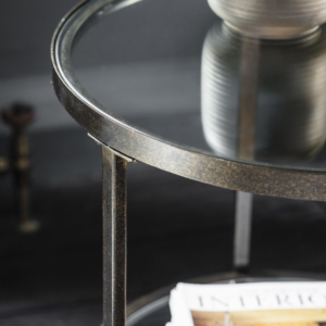 Striking round companion table in an aged bronze finish.