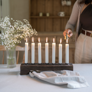 Wooden candle holder with space for 7 standard size dinner candles. Made from reclaimed wood.