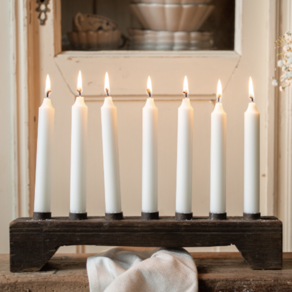 Wooden candle holder with space for 7 standard size dinner candles. Made from reclaimed wood.