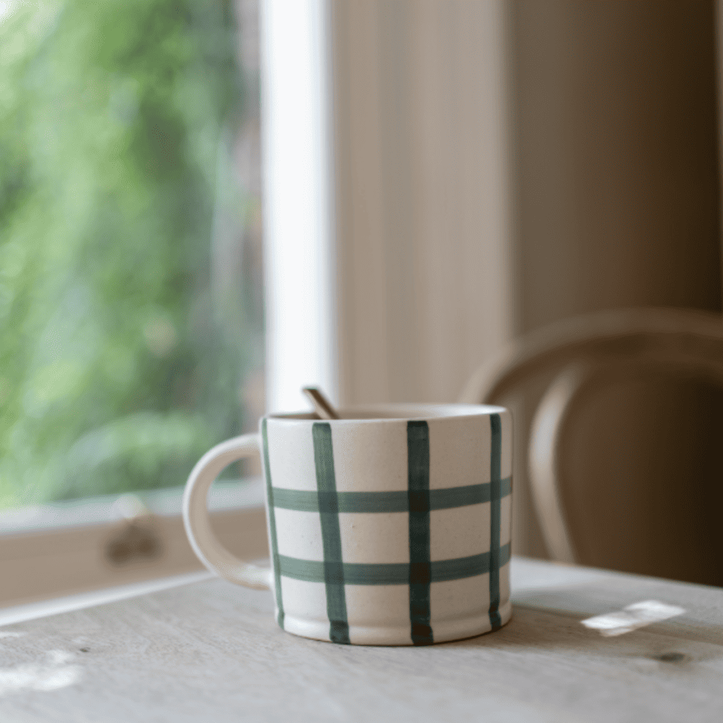 Hand finished matte glazed mug with a painted forest green gingham design.