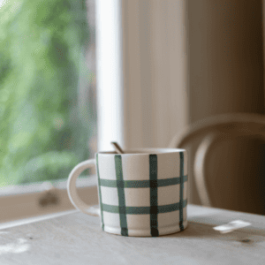 Hand finished matte glazed mug with a painted forest green gingham design.