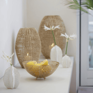 Three Akosi Ceramics White Vases with white flowers in on a white table