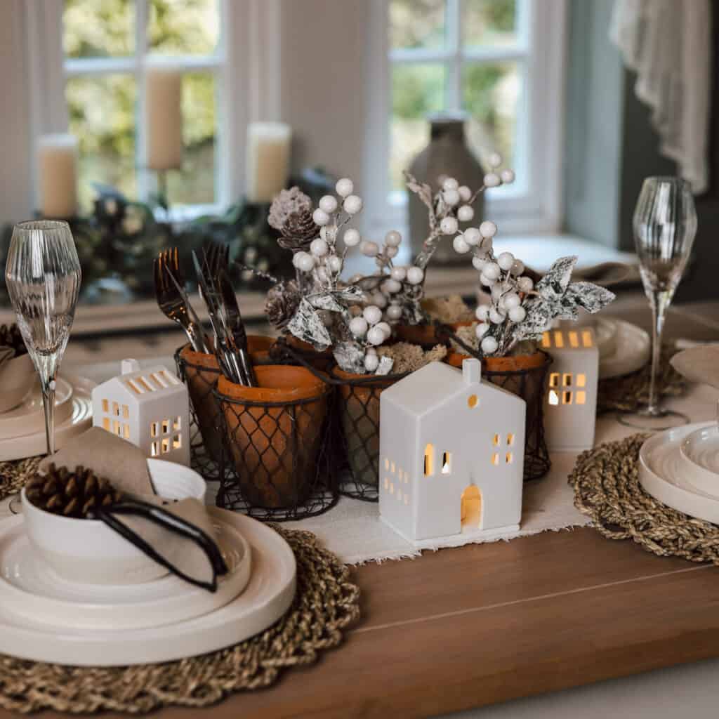 Christmas tablescape with plates, glasses, and champagne glass