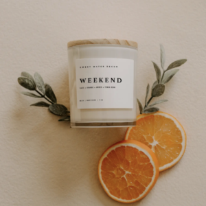 Sweet Water Decor Soy Candle In White Jar Shoot Image with Oranges