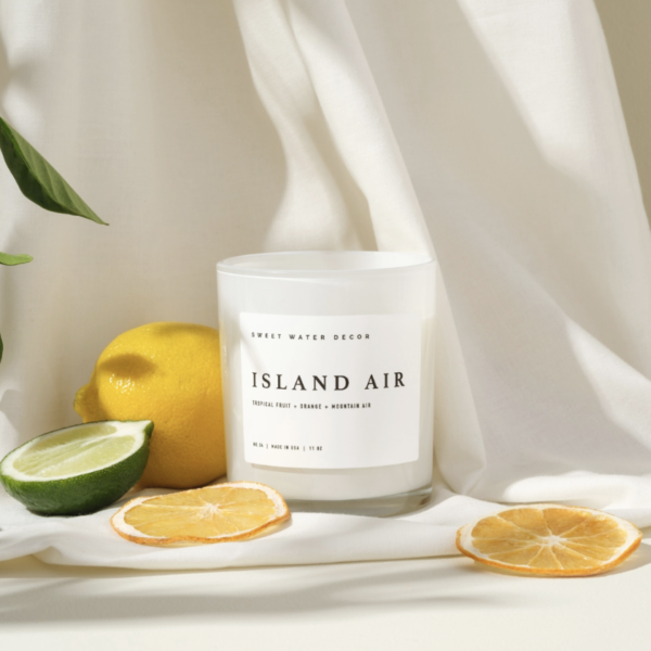 Island Air Soy Wax Candle In White Jar Product With White Background And Citrus Fruits
