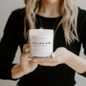 Island Air Soy Wax Candle In White Jar Product Image In Hands