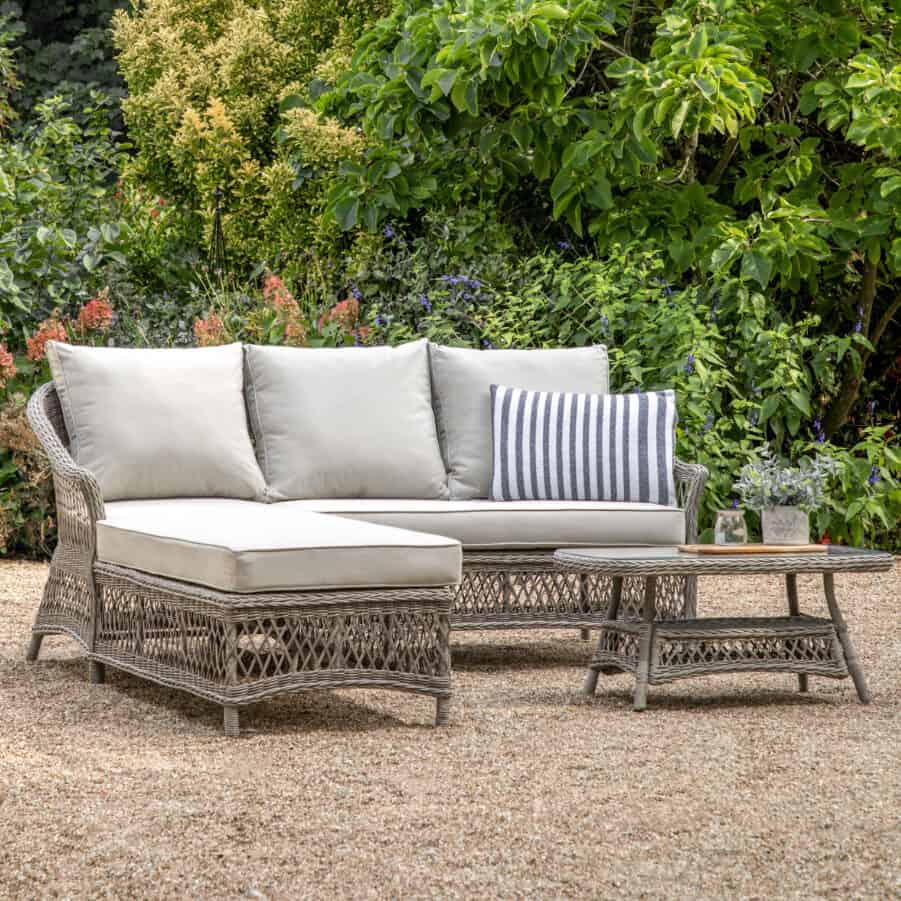Relaxed outdoor seating area with cushion and small coffee table.