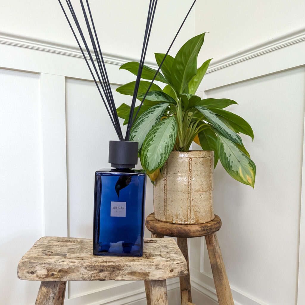 Ocean blue reed diffuser on wooden stool